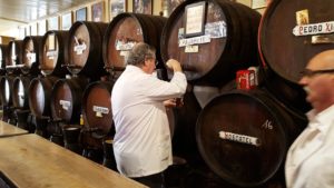 Vin blir servert fra tønner i Bodega de la Guardia, Malaga, Spania.